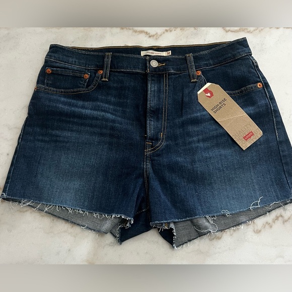 Levi's Pants - Levi's High-Rise shorts in a dark wash stretch denim with a raw hem Size 14